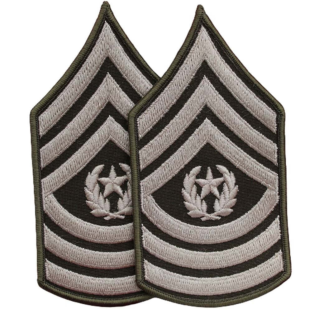 Two identical embroidered military rank insignia patches on a plain white background. Each patch features chevron stripes in light gray and black with a central laurel wreath and star motif.
