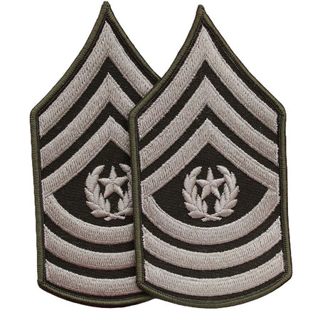 Two identical embroidered military rank insignia patches on a plain white background. Each patch features chevron stripes in light gray and black with a central laurel wreath and star motif.