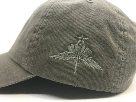 An olive green cotton baseball cap featuring an embroidered gray military-style insignia on the front panel, set against a plain white background.