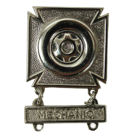 Metallic badge with a wheel design and 'MECHANIC' text on a white background