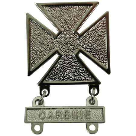 A silver-toned metal military-style insignia featuring a textured cross with a hanging bar engraved with the word 'CARBINE'.