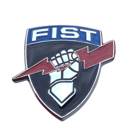 A shield-shaped enamel pin featuring the word 'FIST' in white on a blue background at the top, with a raised fist and red lightning bolt across a dark navy shield below.