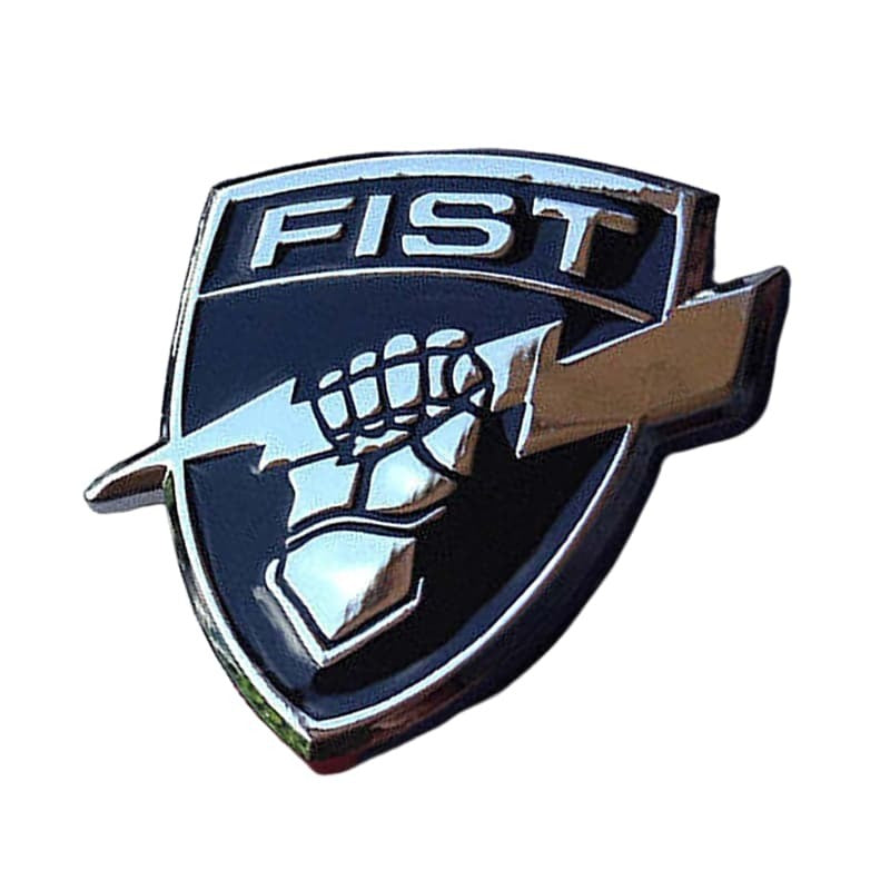 A shield-shaped metal emblem featuring the word 'FIST' in silver at the top, a raised fist in the center, and a silver lightning bolt across the front, shown on a plain white background.